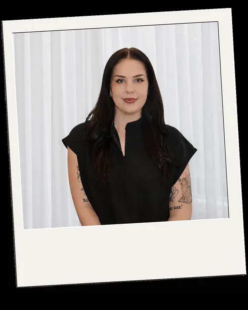Kirra portrait — white sheer-curtain backdrop, natural light, inside a baked polaroid frame