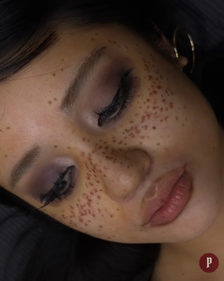 Freckle tattoo — natural scattered freckles across full face close-up