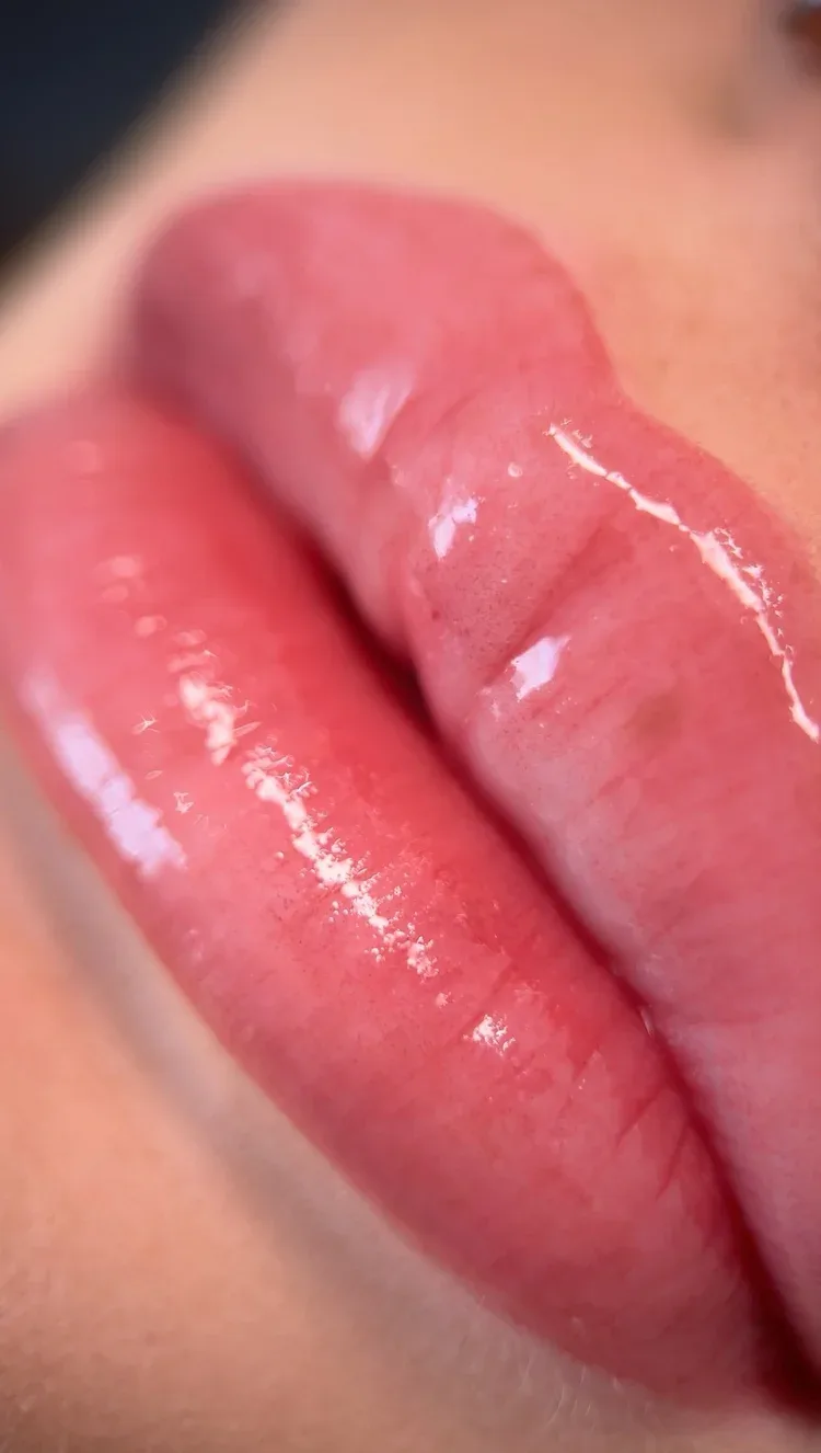 Lip blush tattoo — glossy pink lip macro, tall close-up